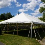30x90 Pole Tent with stone wall Behind it