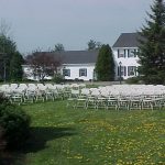 Samsonite Folding Chairs setup for a Wedding Ceremony in front of garden
