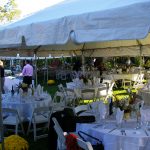 Frame tents with tables set before a wedding
